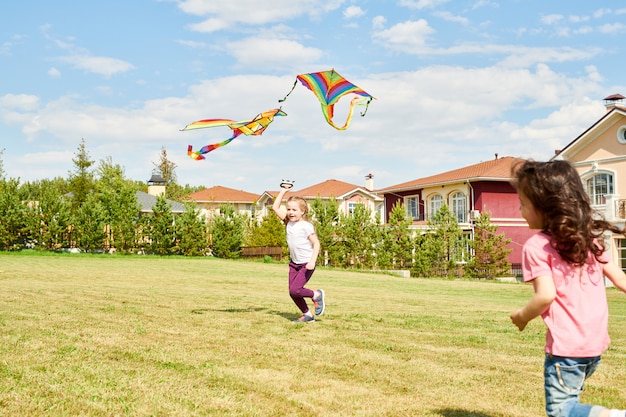 Two Girls Running with Kite