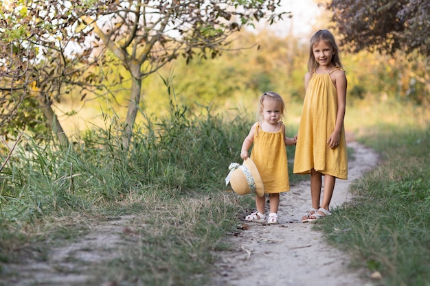 Two girls, seven years old and one age, outdoors