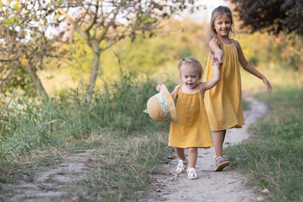 Two girls, seven years old and one age, outdoors