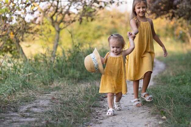 Two girls, seven years old and one age, outdoors