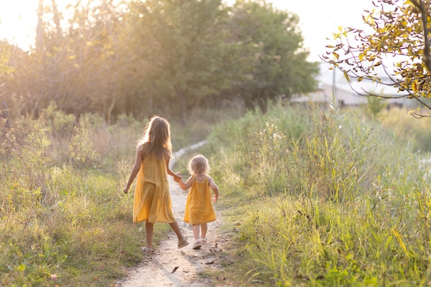 Two girls, seven years old and one age, outdoors