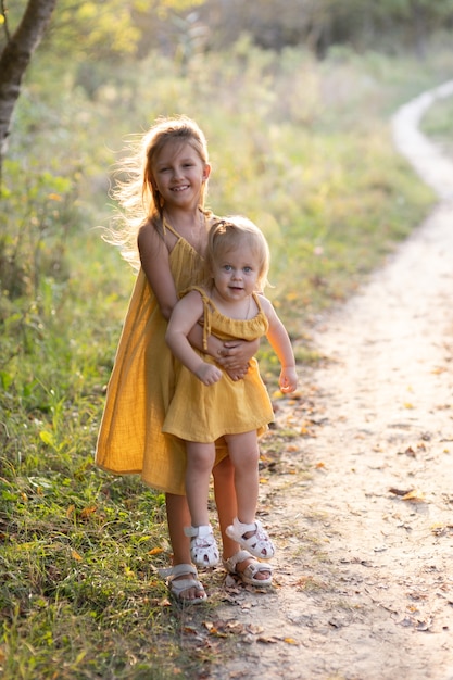 Two girls, seven years old and one age, outdoors