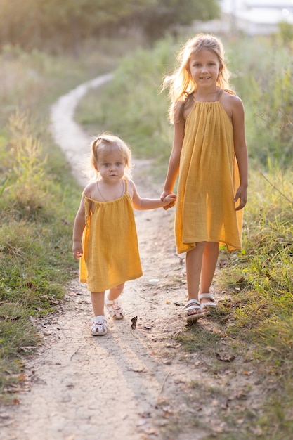 Two girls, seven years old and one age, outdoors