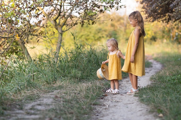 Two girls, seven years old and one age, outdoors