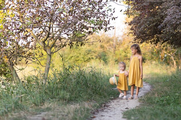 Two girls, seven years old and one age, outdoors