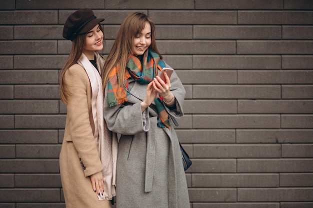 Two girls shopping in an autumn day