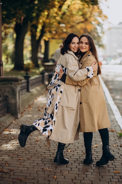 Two girls sisters posing in the street