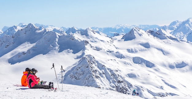 Two girls sitting high up in the mountains