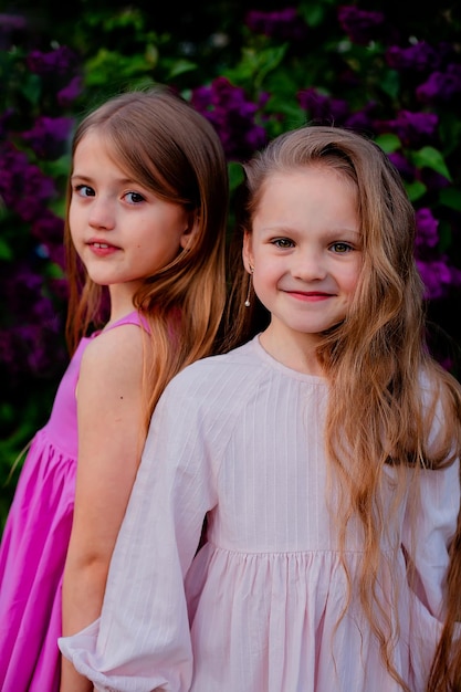 Two girls standing in front of a purple background