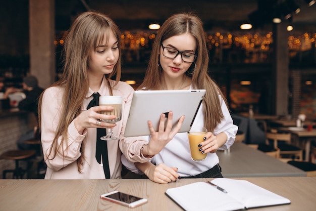 Two girls studying in a cafe