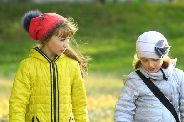 two girls talk to each other outside