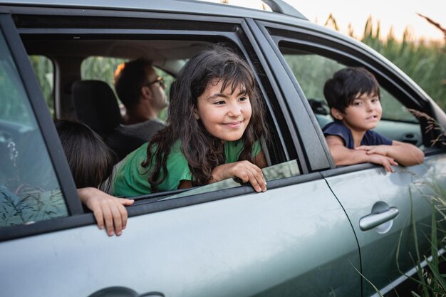 Photo two girls watching from family car windows