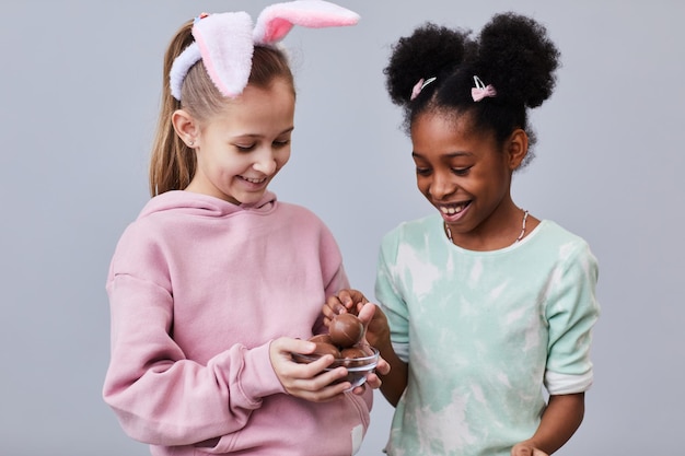 Two Girls with Chocolate Easter Eggs