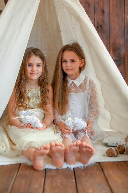 two girls, with a toy rabbit, easter theme