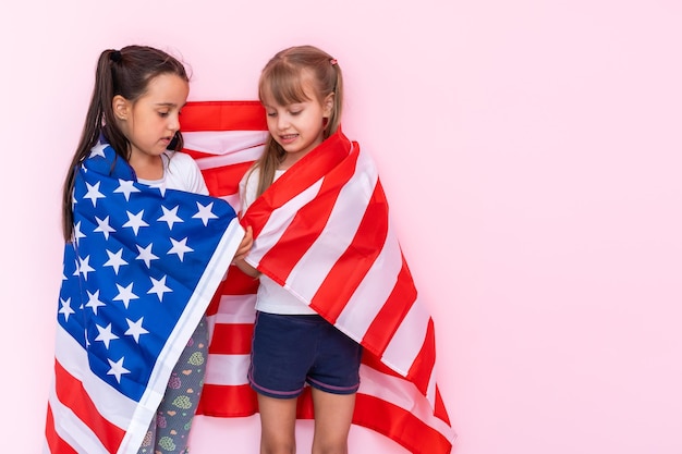 Two girls wrapped in a US flag