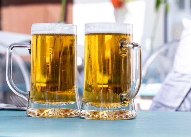 Two glass cups of a beer