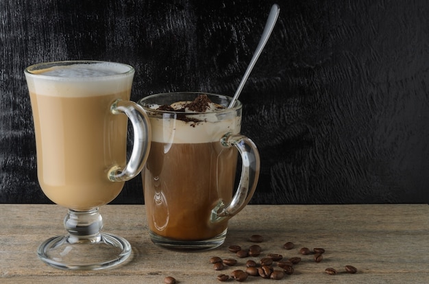 Two glass cups with a cappuccino and an iced chocolate