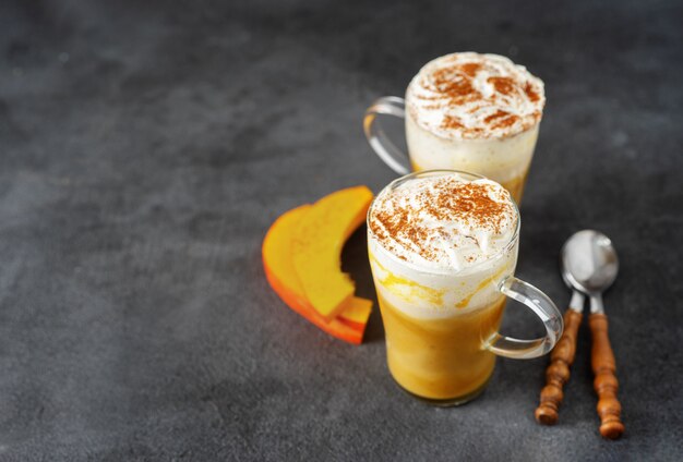 Two glass cups with spice pumpkin cappuccino