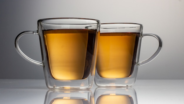 Two glass teapots with tea