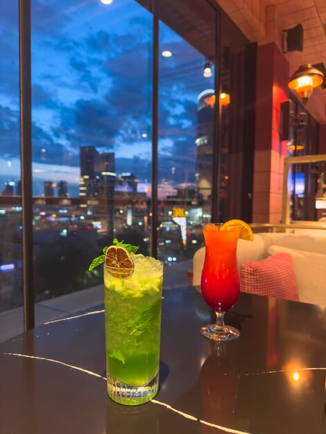 Two glass with cocktail drink on white table on sunny summer restaurant terrace