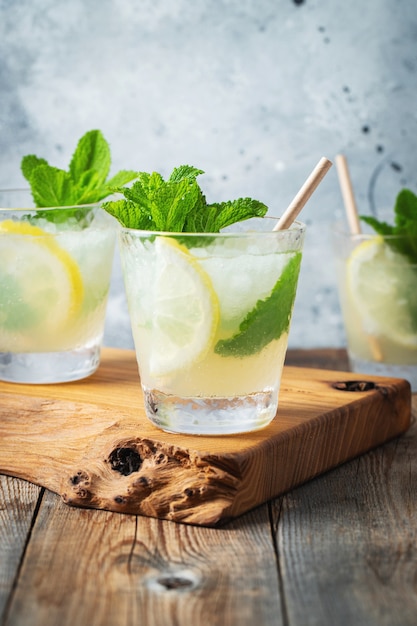 Two glass with lemonade or mojito cocktail with lemon.