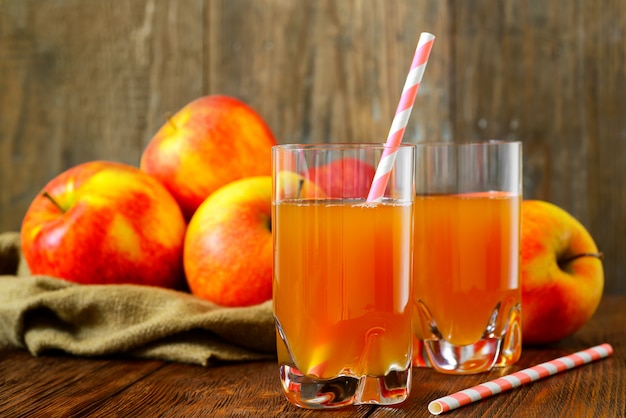 Two glasses of apple juice with apples