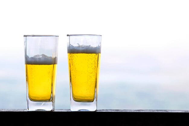 Two glasses of beer on a blurred background
