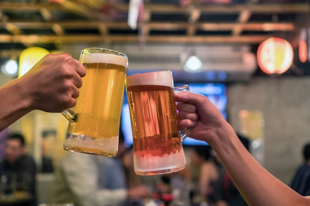 Two Glasses of Beer cheers together between friend 