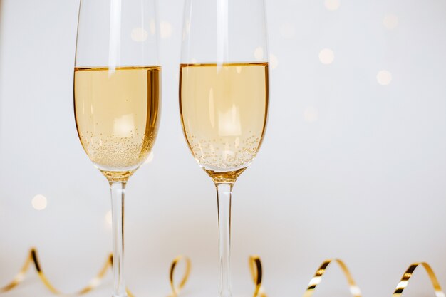 Two glasses of champagne with golden ribbon