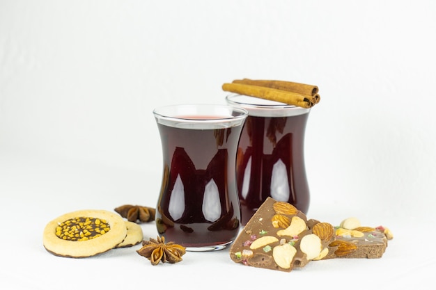 Two glasses of mulled wine with spices biscuits and chocolate for Christmas