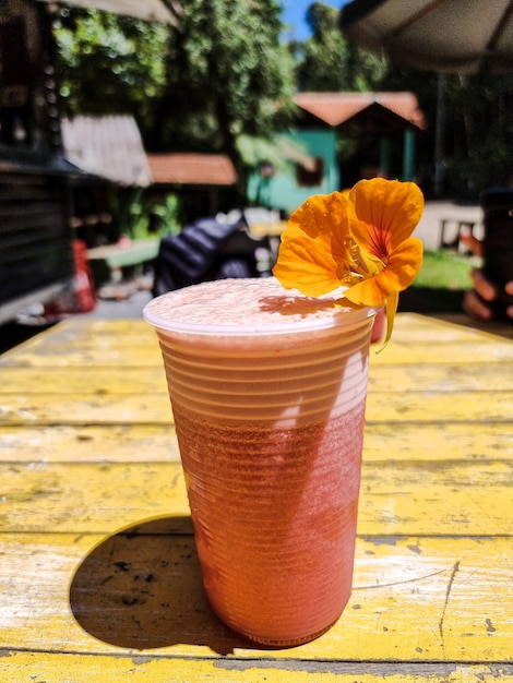 Two glasses of natural juice decorated with flowers