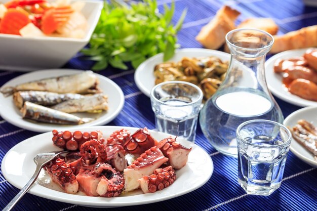 Two glasses of ouzo and appetizers