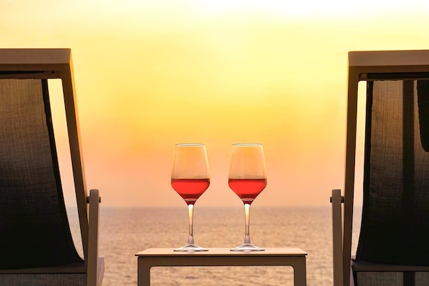 Two glasses of red wine on the background of the sea