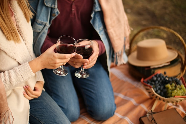 Two glasses of red wine in hand on a date.