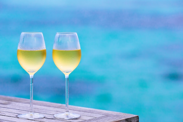 Two glasses of tasty white wine the sea