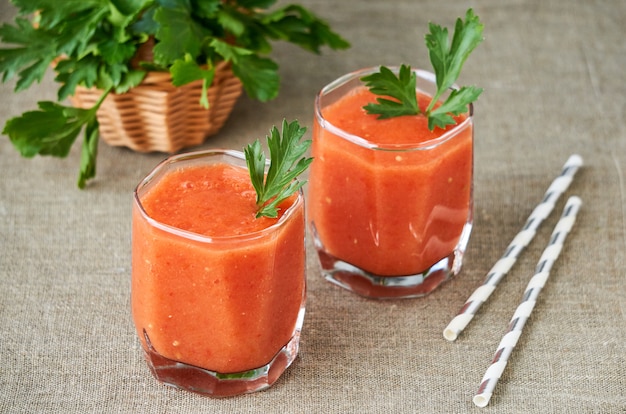 Two glasses of tomato smoothie with parsley