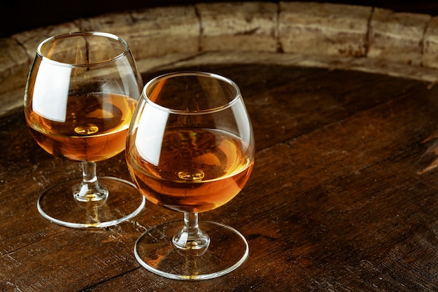 Two glasses of whiskey on a wooden table in the bar