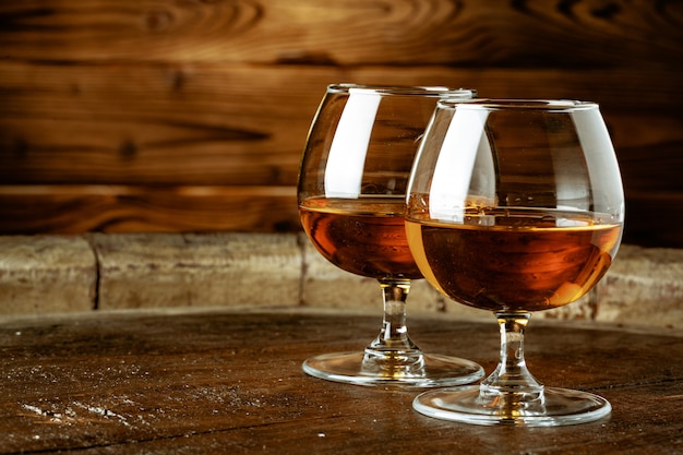 Two glasses of whiskey on a wooden table in the bar