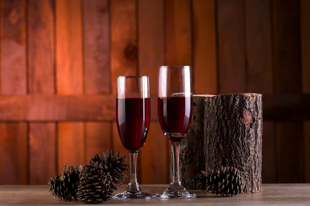 two glasses of wine on wooden background