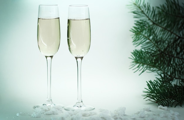 Two glasses with champagne on christmas background