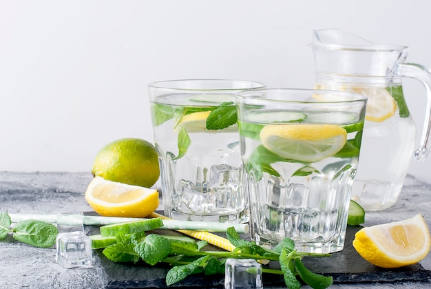 Two Glasses with detox fresh organic cucumber, lemon and mint water 