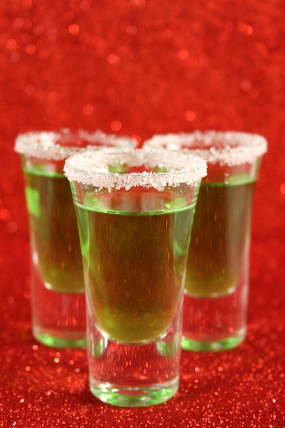 Two glasses with a green cocktail