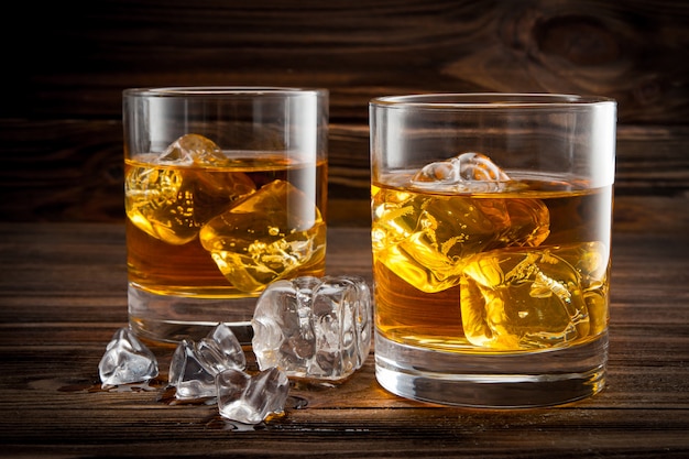 Two glasses with ice and whiskey