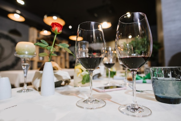 Two glasses with red wine on the served table at the restaurant