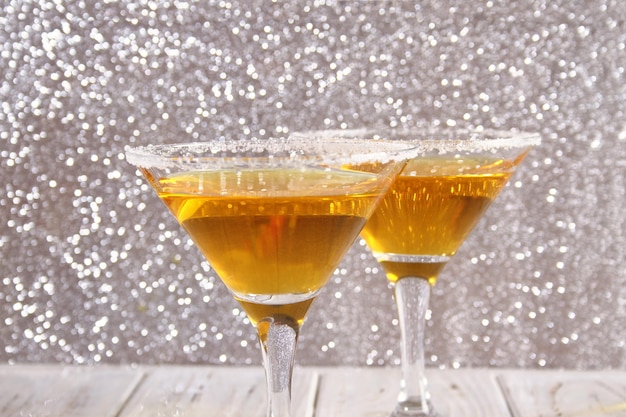 Two glasses with a yellow cocktail