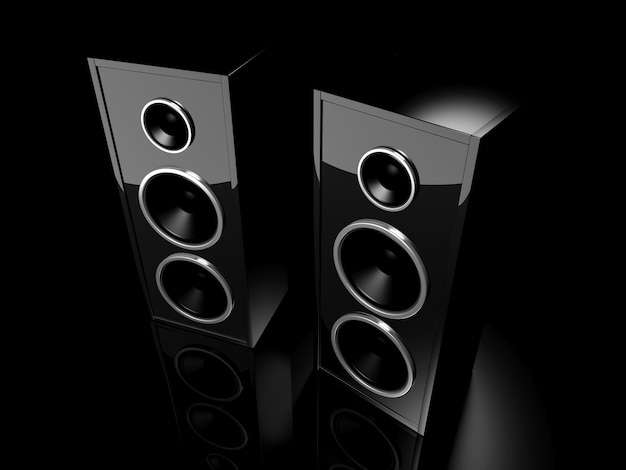 Two glossy black speakers with reflection on black background