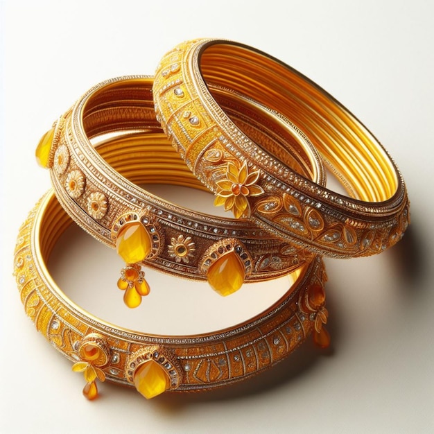 two gold bangles with the word  tato  written on them