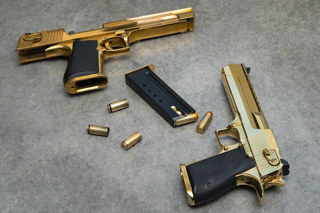 Two gold guns desert eagle and ammo