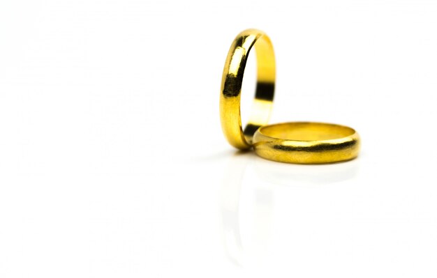 Two gold wedding ring isolated on white with copy space