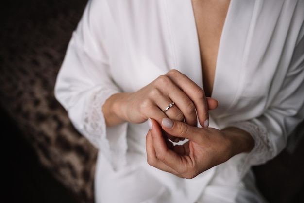 Two gold wedding rings the bride wears the groom wedding ring newlyweds with rings on fingerswedding ceremony outdoor the couple exchanges the wedding rings just married